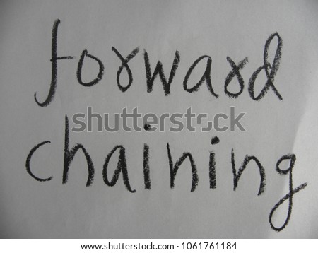 Text forward chaining hand written by black color oil pastel on paper