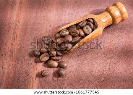 Roasted coffee on the wooden background - Coffee