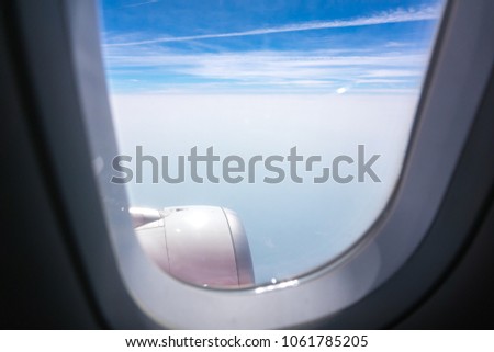 Blurred view sky blue or azure sky and clouds from window of airplane