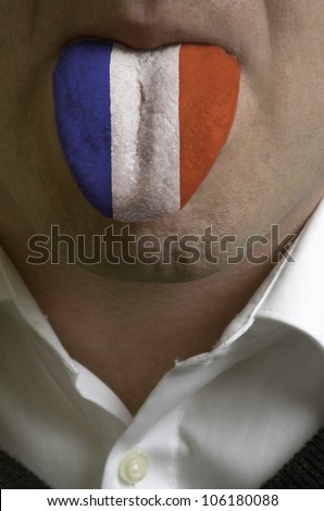 man with open mouth spreading tongue colored in france flag as symbol of values like teaching, learning, multilingual speaking different of languages