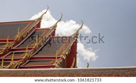 art of Buddhism house of worship temple roof in traditional style by red, orange and green color of tile on top roof and Thai architecture