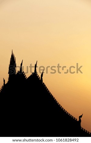 Silhouette picture of Buddhist monastery roof represents detail and  delicacy of Buddhist art in Laos.