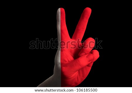 Hand with two finger up gesture in colored bahrain national flag as symbol of winning,  - for tourism and touristic advertising, positive political, cultural, social management of country