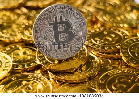New cryptocurrency on golden bitcoins background.