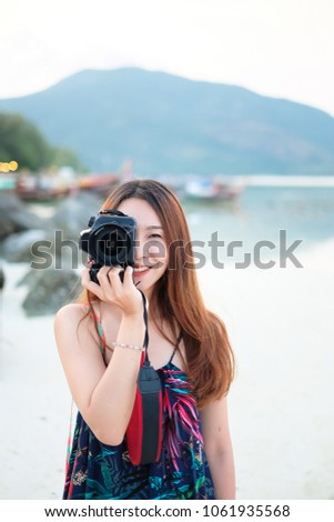 photography , camera girl take a photo  at the sea beach  