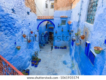 Traditional old blue street with color pots inside Medina of Chefchaouen, Morocco