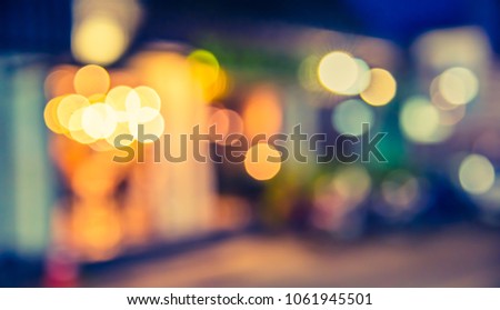 image of blur restaurant or cafe on night time with  light bokeh for background usage . (vintage tone)