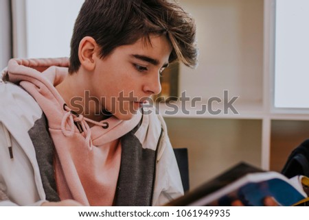 young teenager reading the book or magazine Royalty-Free Stock Photo #1061949935