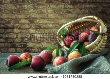 Still life with basket of ripe peaches