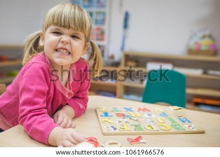 Cutecaucasian baby girl smiling in kindergarten