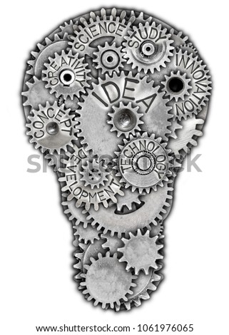 Photo of metal plate in a light bulb shape and tooth wheels with IDEA concept related words imprinted on metal surface isolated on white