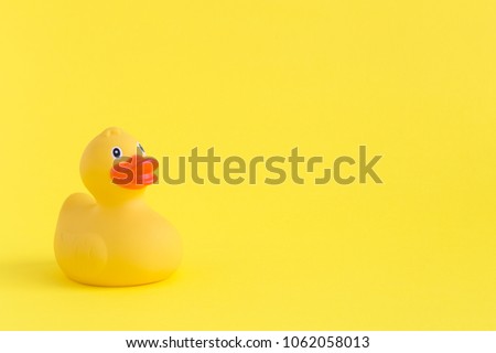 Rubber duck on yellow background minimal creative concept. Space for copy.