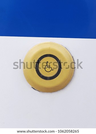 Disabled symbol button on a bus, frontal shot