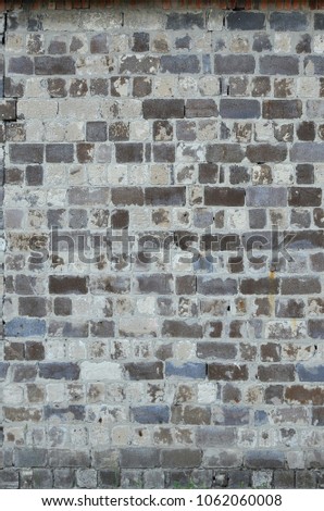 The texture of the warehouse wall from a variety of rough stones of different shades