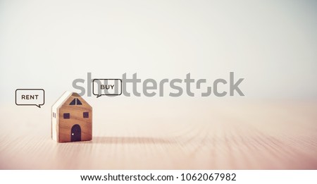 Close up Hand holding home with Buy or Rent, copy space. Royalty-Free Stock Photo #1062067982