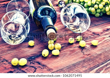 Wine and grapes. White wine in a bottle and in glasses. Still life