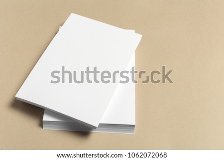 White business card on wooden table. Blank portrait A4.
