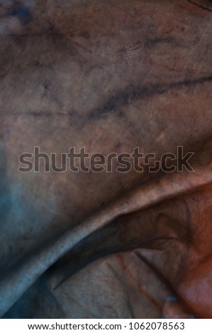 Abstract closeup detail of a weathered tarpaulin with colors 