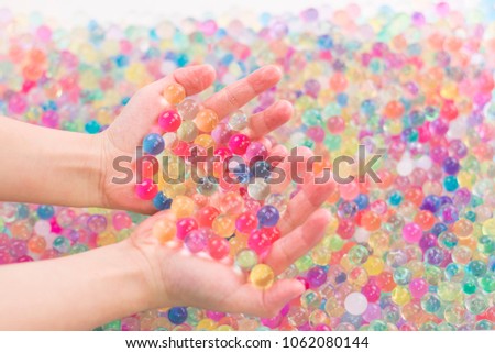 children hands in colorful water ball
