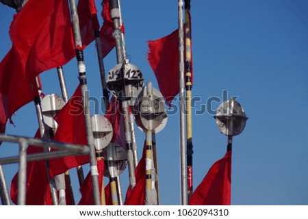 A jagged red flags in the wind on fishing boat
