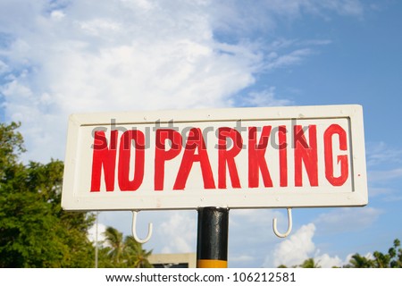 image of a street sign "no parking", with sky in the background.