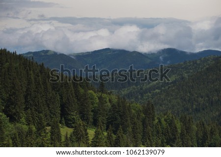 Beautiful cloudy mountain landscape. Horizontal color photography.