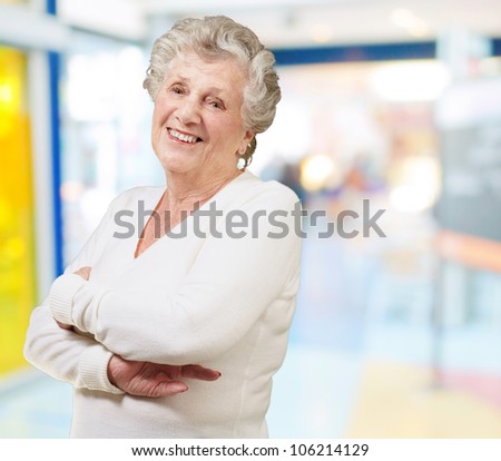 portrait of a senior woman smiling against a modern building