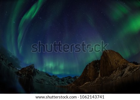 Aurora Borealis/Northern Lights Over Festhelltinden and Olstinden mountain by Fisheye Lens, Lofoten, Norway