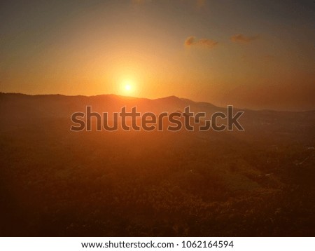 Aerial view of sunset over mountain jungle