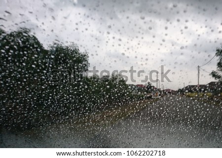 Rainy days, rain drops on the window blur. Blurry car glass. Autumn Abstract Backdrop  