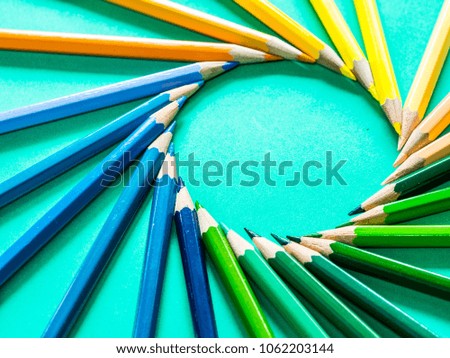 Set of pencils color in circle set up on green background for art concept, selective focus 