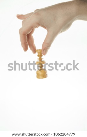 female hand taking chess piece on white background