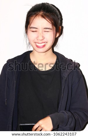 Portrait of Asian Woman on white background. Shooting with 1980 fashion style use hard light and compact camera. Height contrast and look like 35mm film tone.
