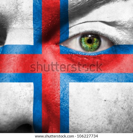 Flag painted on face with green eye to show Faroe island support