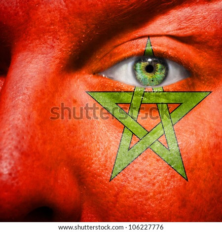Flag painted on face with green eye to show morocco support