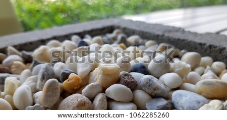pebble various colour in the cement box mixing close up selective focus point