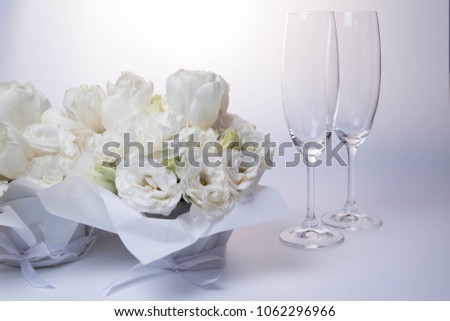 two glasses and white bouquet on the white background