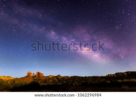 The Milky Way Galaxy arches across the night sky above Cathedral Rock in Sedona, Arizona.