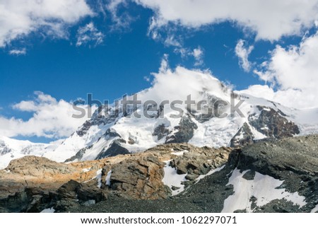 View on Monte Rosa massif with highest peak of Switzerland - Dufourspitz, for now hidden in clouds Royalty-Free Stock Photo #1062297071