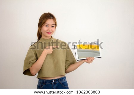 Portrait of thai china adult beautiful girl using her tablet.
