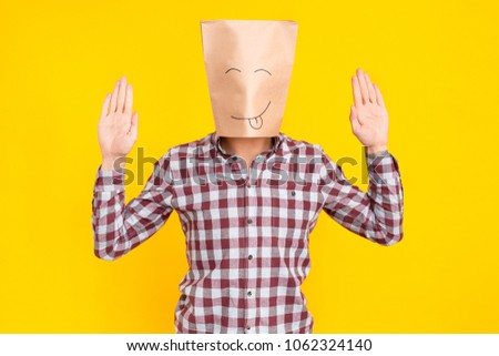 Man with package on head, hands up, drawn funny face