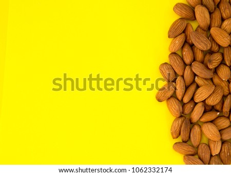 Raw Natural Organic Almonds Nuts Scattered Isolated on Yellow Background Top View Healthy Food for Life Natural Light Selective Focus