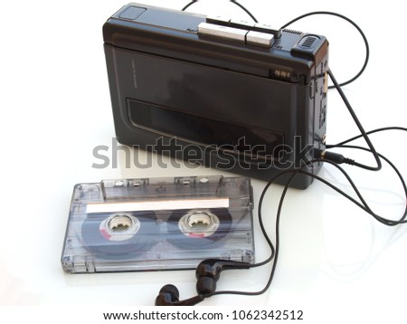 vintage music cassette tape and walkman recorder over white white background