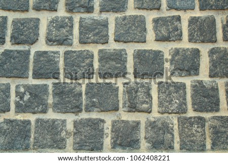 Sidewalk black square tile. Cobblestone paving. Background. Texture.
