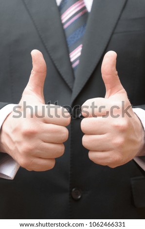 A businessman in an expensive suit makes a gesture with his hand - everything is ok
