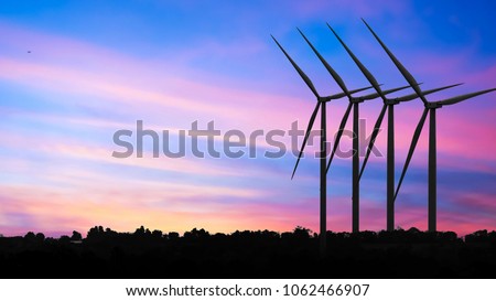 Wind Turbines In Rural Landscape At Sunset. renewable energy with wind turbines Royalty-Free Stock Photo #1062466907