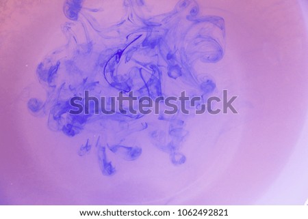 blue ink in pink water/ ink abstract background 
