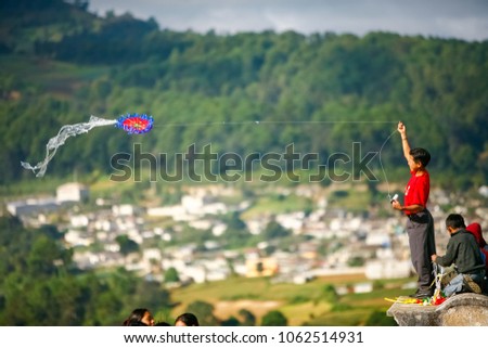 All Saints Day in Santiago Sacatepequez Guatemala, an important festivity that takes place on the town cemetery with beautiful handmade giant and colorful kites. Royalty-Free Stock Photo #1062514931