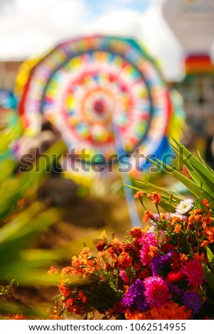 All Saints Day in Santiago Sacatepequez Guatemala, an important festivity that takes place on the town cemetery with beautiful handmade giant and colorful kites. Royalty-Free Stock Photo #1062514955