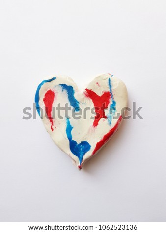 figure of heart, with the colors white, blue and red plasticine 